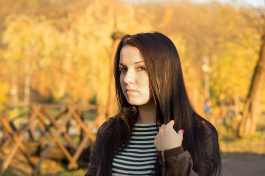 beautiful and sexy girl sitting on bench outdoors. 