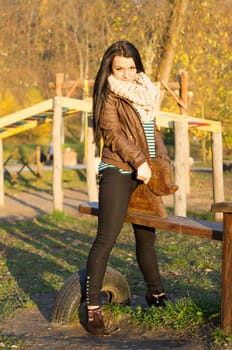 beautiful and sexy girl sitting on bench outdoors. 