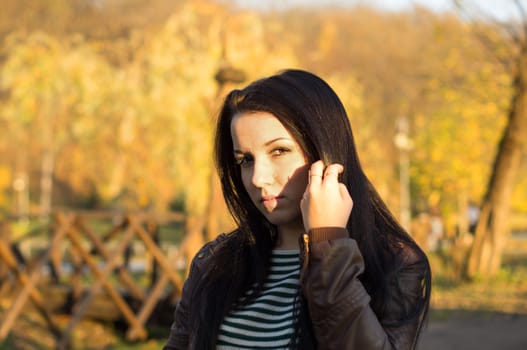 beautiful and sexy girl sitting on bench outdoors. 