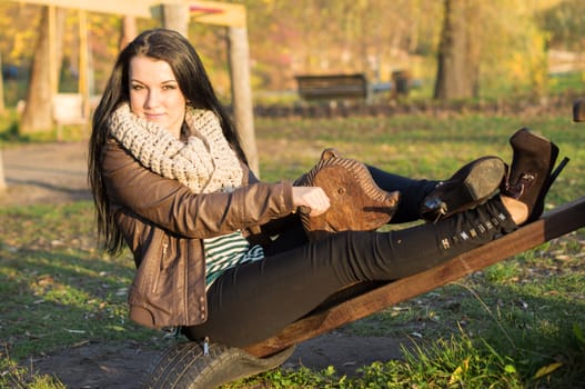 beautiful and sexy girl sitting on bench outdoors. 