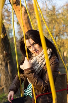 beautiful and sexy girl sitting on bench outdoors. 