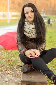 beautiful and sexy girl sitting on bench outdoors. 