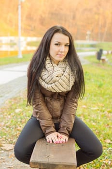 beautiful and sexy girl sitting on bench outdoors. 