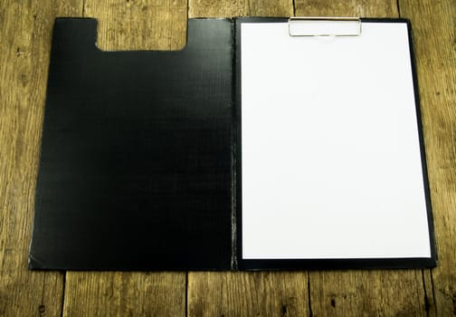 White paper on wood background. For your commercial and editorial use