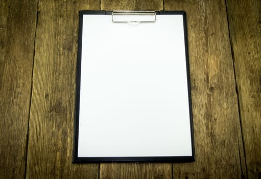 White paper on wood background. For your commercial and editorial use