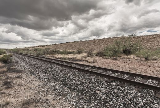 Single line of railroad tracks in Arizona desert