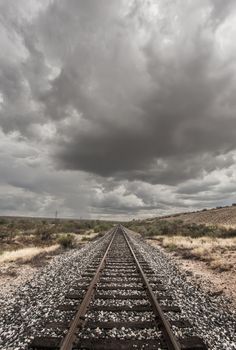 Single railroad track with monsoon clouds above
