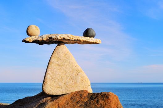 Symbol of scales on the top of boulder