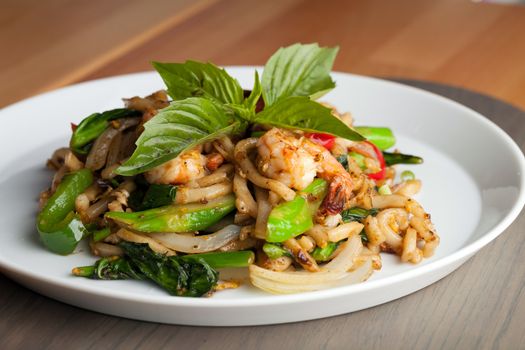 Thai food shrimp stir fry with lo mein noodles Shallow depth of field.