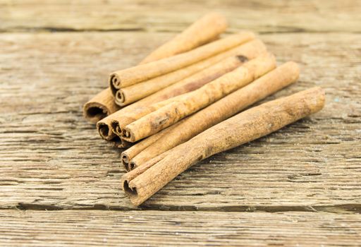 Close up of cinnamon sticks on rustic wood . For your commercial and editorial use.