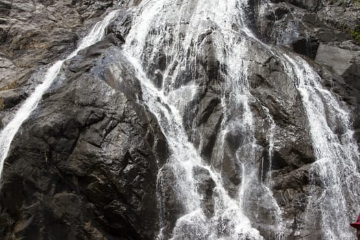 Waterfall in the jungle, a beautiful view of the steep rock .Indiya Goa.