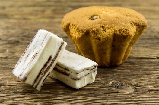 Tasty cupcake on wooden table. For your commercial and editorial use.