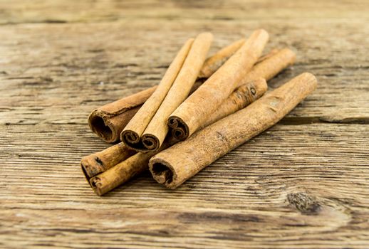 Close up of cinnamon sticks on rustic wood . For your commercial and editorial use.