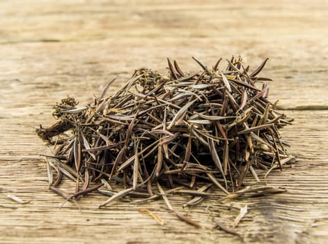 A pile of marigold seeds is ready to plant in a spring garden on wooden background