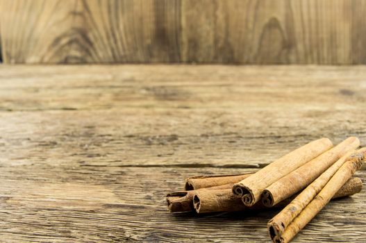 Close up of cinnamon sticks on rustic wood . For your commercial and editorial use.