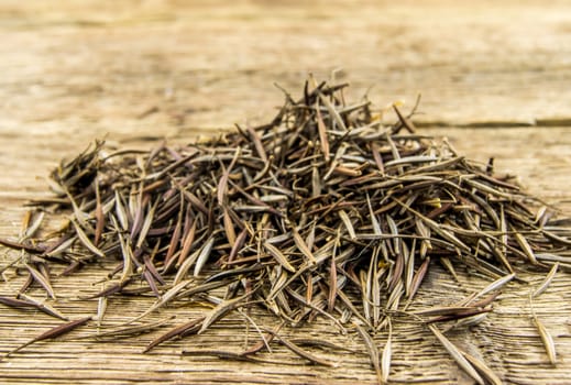 A pile of marigold seeds is ready to plant in a spring garden on wooden background