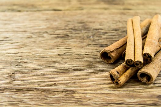Close up of cinnamon sticks on rustic wood . For your commercial and editorial use.