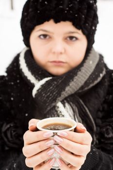 woman with cup of coffee in the winter park. For your commercial and editorial use.