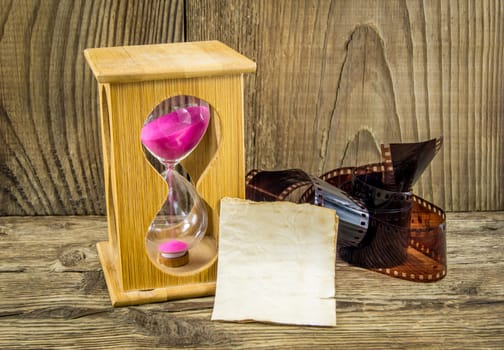 Hourglass with space for text on the wooden background.