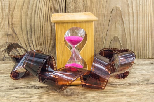 Hourglass with space for text on the wooden background.