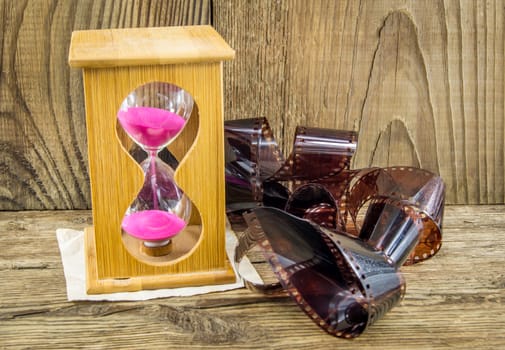 Hourglass with space for text on the wooden background.