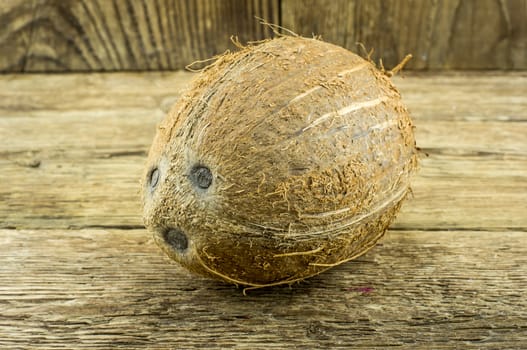 coconut and lie on a wooden background.