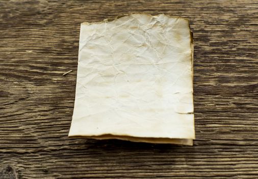 old paper  lie on a wooden background.