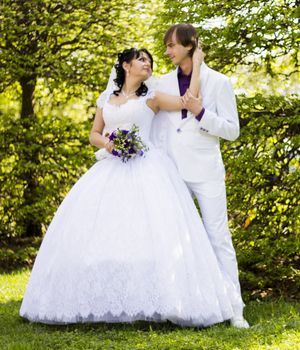 Elegant bride and groom posing together outdoors on a wedding day