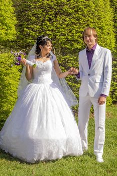 Elegant bride and groom posing together outdoors on a wedding day