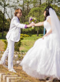 Forest in focus and couple in the background. For your commercial and editorial use.