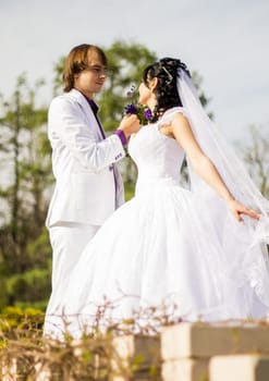 Elegant bride and groom posing together outdoors on a wedding day