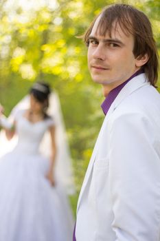The bride and groom in the background. For your commercial and editorial use.