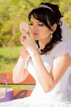 young bride is doing makeup. For your commercial and editorial use.