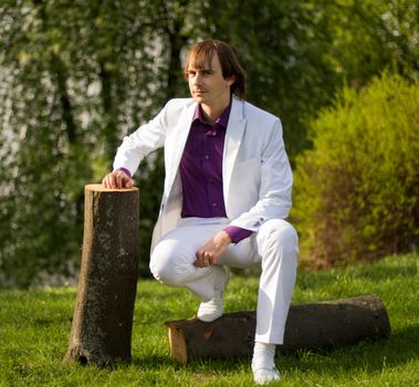 guy sitting on a tree stump. For your commercial and editorial use.