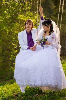 bride and groom swinging on a swing. For your commercial and editorial use.