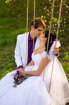 bride and groom swinging on a swing. For your commercial and editorial use.