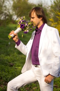 Man Sniffing A Flower. For your commercial and editorial use.