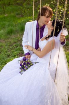 bride and groom swinging on a swing. For your commercial and editorial use.