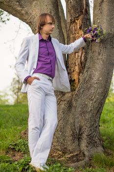 Handsome man wearing bouquet of flowers. For your commercial and editorial use.