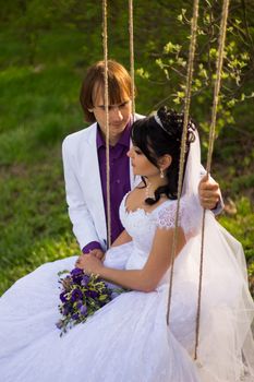 bride and groom swinging on a swing. For your commercial and editorial use.