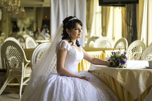 Happy young bride with wedding bouquet. For your commercial and editorial use.