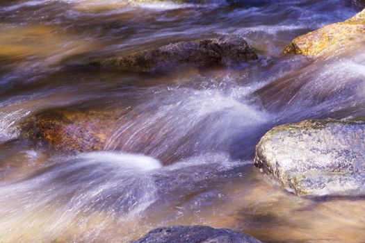 Picturesque and silky rush of river water over boulders at scenic Ken Lockwood Gorge in New Jersey's Lebanon Township region of Hunterdon County.     South Branch of the Raritan River flows through wildlife management area. 