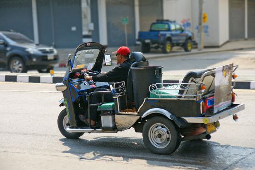 CHIANGMAI,THAILAND-APRIL 14,2011:Unidentified taxi driver with traditional tuk-tuk in a water fight festival or Songkran Festival (Thai New Year), on April 14, 2011 in Chiangmai, Thailand.