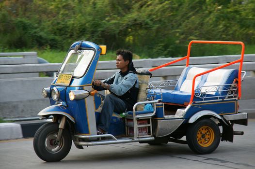 CHIANGMAI,THAILAND-APRIL 14,2011:Unidentified taxi driver with traditional tuk-tuk in a water fight festival or Songkran Festival (Thai New Year), on April 14, 2011 in Chiangmai, Thailand.