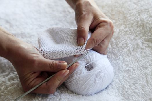 female hands with needles and threads