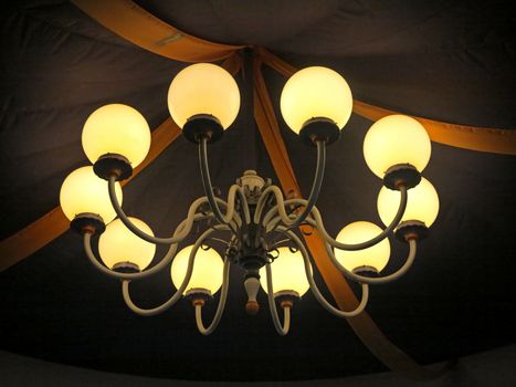 A large light hanging from the top of a tent