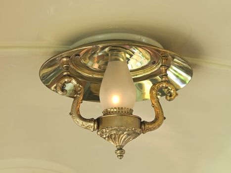 A gold lamp hanging from the ceiling