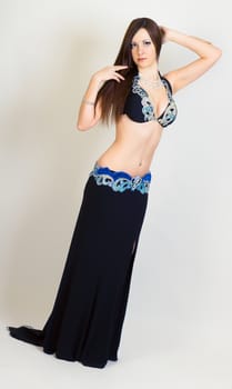 young woman dressed as a performing belly dancing. Studio. full height