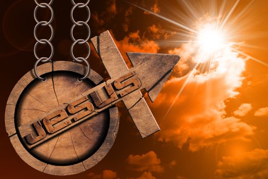 Wooden symbol with cross and arrow upward and text Jesus. Hanging from a chain at sunset  with cloudy sky and sun rays