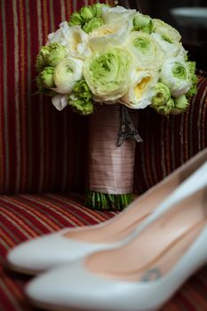 wedding shoes and wedding bouquet of white roses